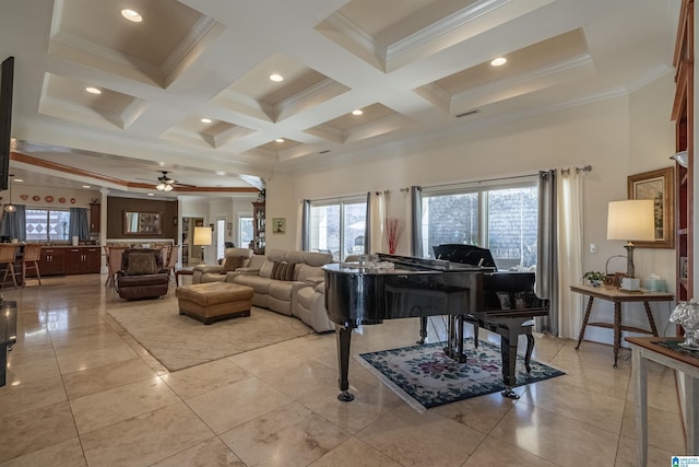 living area with plenty of natural light, a ceiling fan, and coffered ceiling