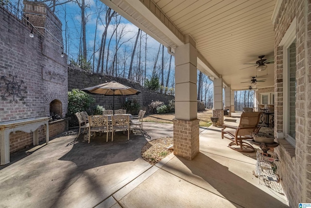 view of patio with outdoor dining area and ceiling fan