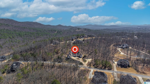 bird's eye view featuring a wooded view and a mountain view