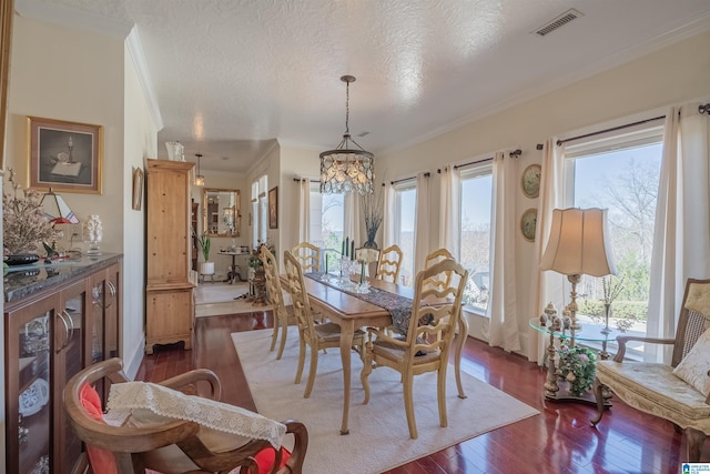 dining area with a notable chandelier, dark wood-style floors, visible vents, and a healthy amount of sunlight