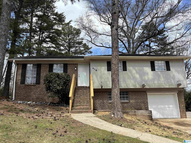 view of front of property with concrete driveway, a garage, and brick siding