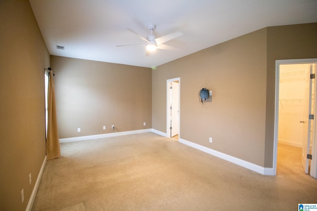 unfurnished room featuring light carpet, a ceiling fan, visible vents, and baseboards