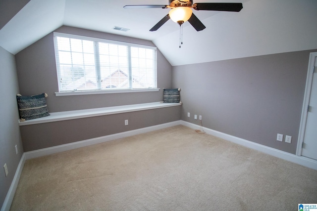 additional living space with visible vents, baseboards, carpet floors, vaulted ceiling, and a ceiling fan