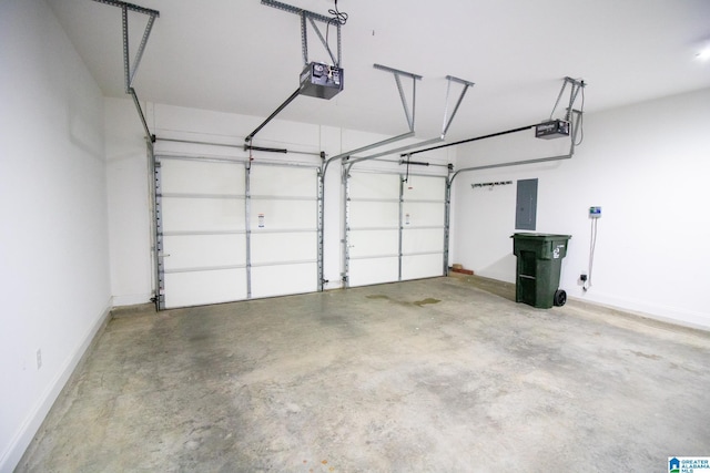 garage with electric panel, a garage door opener, and baseboards