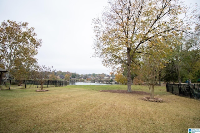 view of yard with fence and a water view