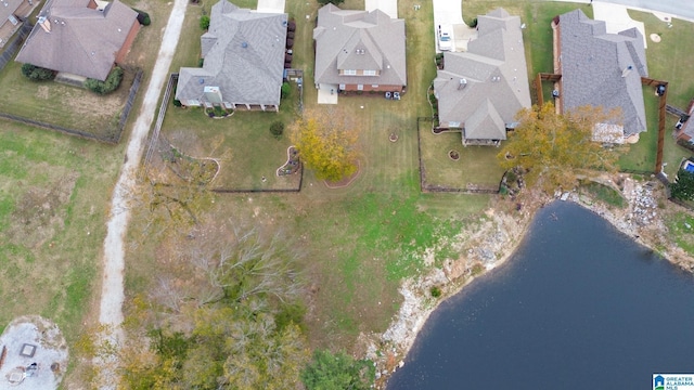 drone / aerial view with a residential view and a water view