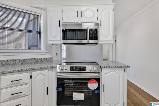 kitchen featuring white cabinetry and appliances with stainless steel finishes