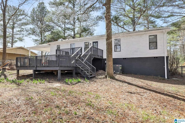 rear view of property with crawl space, central air condition unit, and a deck