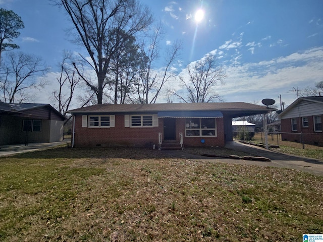 single story home with brick siding, an attached carport, fence, a front yard, and driveway