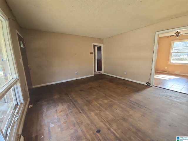 empty room featuring baseboards and wood finished floors