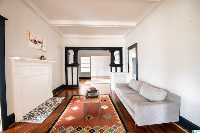 living room with beamed ceiling, baseboards, wood finished floors, and ornamental molding