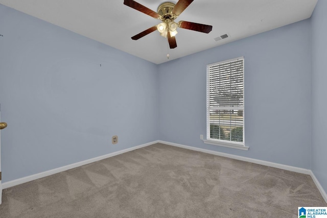 empty room with visible vents, baseboards, carpet, and ceiling fan