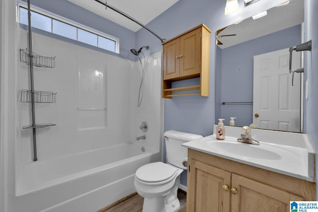 bathroom with vanity, toilet, a ceiling fan, and shower / bathtub combination