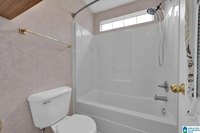 bathroom with toilet and bathtub / shower combination