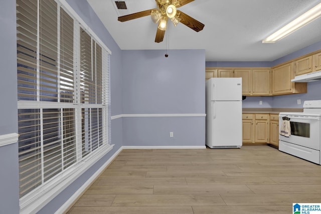 kitchen featuring light brown cabinetry, visible vents, white appliances, and under cabinet range hood