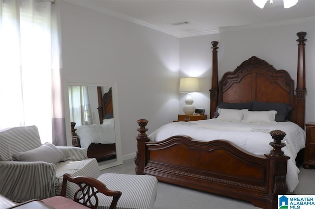 bedroom featuring visible vents, crown molding, and carpet floors