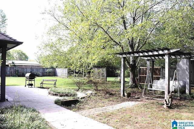 view of yard with a patio area, a pergola, and fence