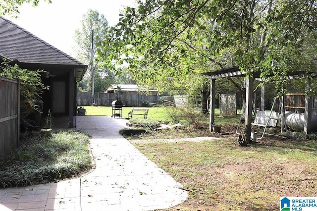 view of yard featuring a patio, a fenced backyard, and a pergola