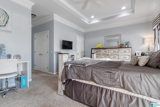 carpeted bedroom featuring recessed lighting, baseboards, a tray ceiling, and ornamental molding