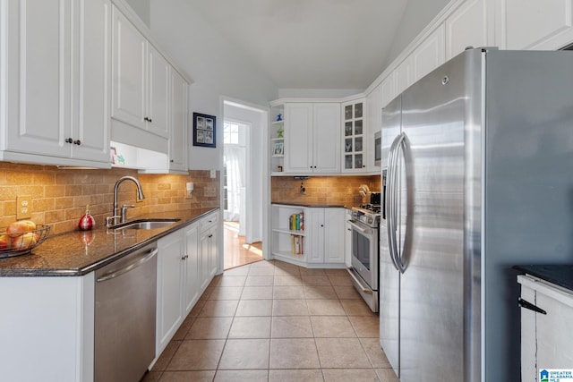 kitchen with open shelves, light tile patterned floors, appliances with stainless steel finishes, and a sink