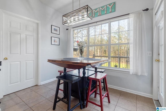 dining space with tile patterned floors and baseboards