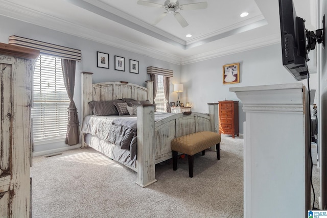 bedroom with carpet flooring, multiple windows, crown molding, and a raised ceiling