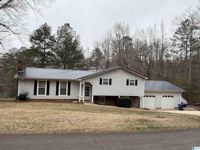 236 Oak Ridge Dr, Oneonta, AL 35121 - view of front of home featuring an attached garage, metal roof, a front lawn, and driveway