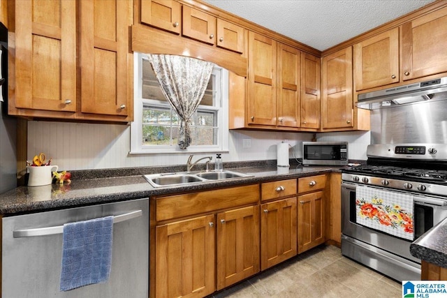 236 Oak Ridge Dr, Oneonta, AL 35121 - kitchen with under cabinet range hood, a sink, dark countertops, and appliances with stainless steel finishes
