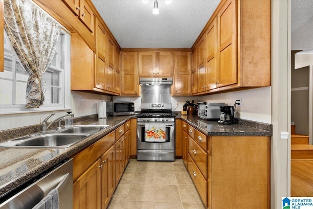 236 Oak Ridge Dr, Oneonta, AL 35121 - kitchen with brown cabinetry, under cabinet range hood, a sink, and stainless steel appliances