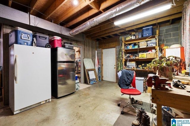 236 Oak Ridge Dr, Oneonta, AL 35121 - unfinished basement featuring concrete block wall and freestanding refrigerator