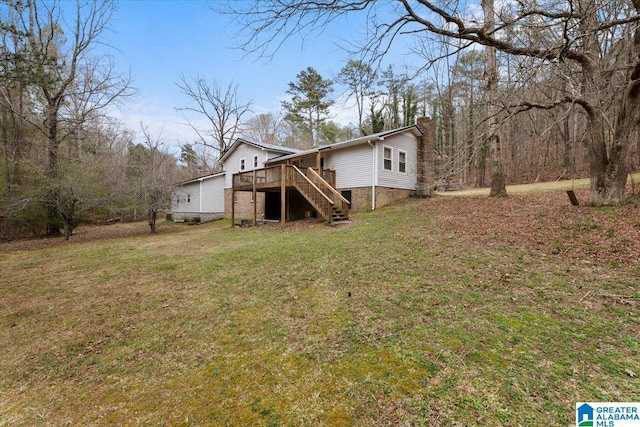 236 Oak Ridge Dr, Oneonta, AL 35121 - back of property featuring stairs, a chimney, a deck, and a yard
