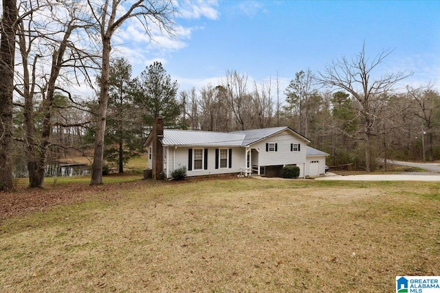 236 Oak Ridge Dr, Oneonta, AL 35121 - tri-level home with concrete driveway, a chimney, a front lawn, metal roof, and a garage