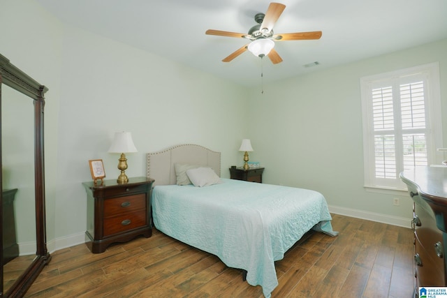 bedroom featuring visible vents, baseboards, ceiling fan, and dark wood-style flooring