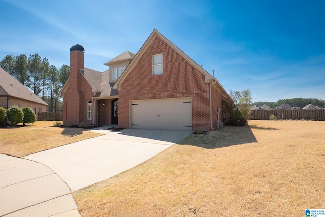 traditional home with fence, concrete driveway, a front yard, brick siding, and a chimney