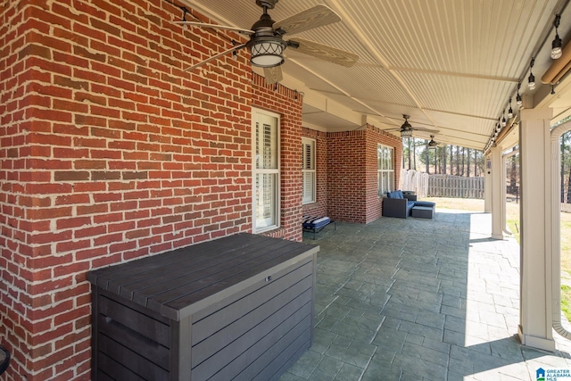 view of patio / terrace featuring ceiling fan and fence