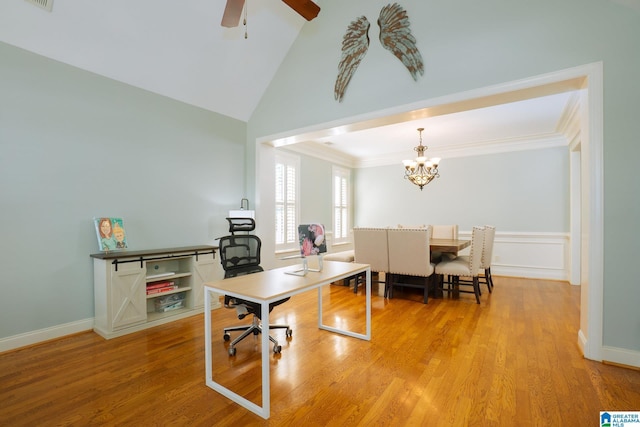 home office featuring light wood finished floors, visible vents, ornamental molding, ceiling fan with notable chandelier, and high vaulted ceiling