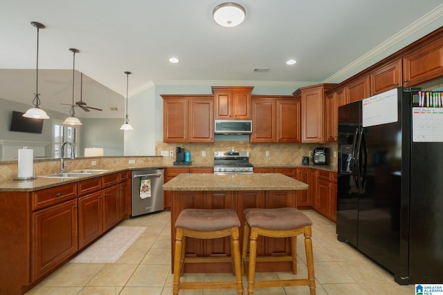 kitchen with a kitchen island, a peninsula, light tile patterned flooring, a sink, and stainless steel appliances