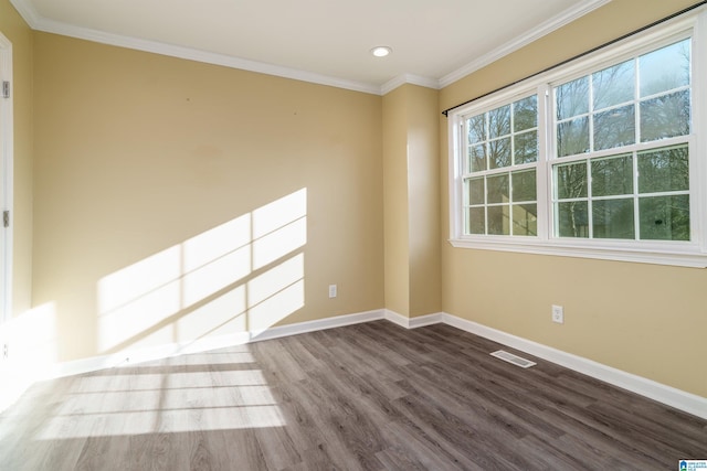 empty room featuring visible vents, ornamental molding, wood finished floors, recessed lighting, and baseboards