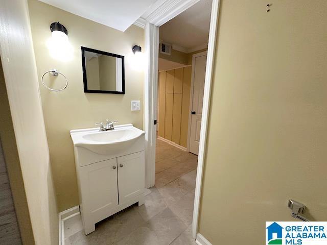 bathroom featuring vanity, baseboards, and visible vents