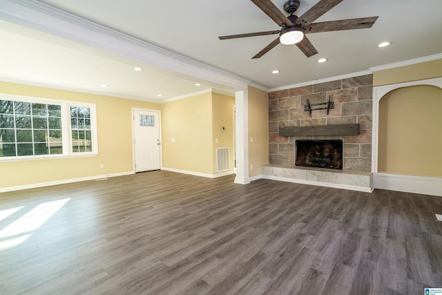 unfurnished living room with visible vents, baseboards, a fireplace, and crown molding