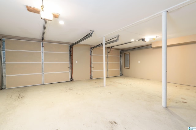 garage with electric panel and a garage door opener