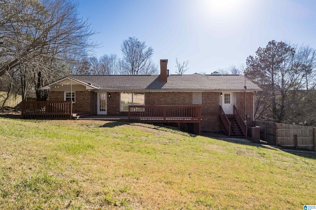 back of house featuring a deck, a yard, fence, and brick siding