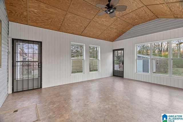 unfurnished sunroom featuring a ceiling fan and vaulted ceiling