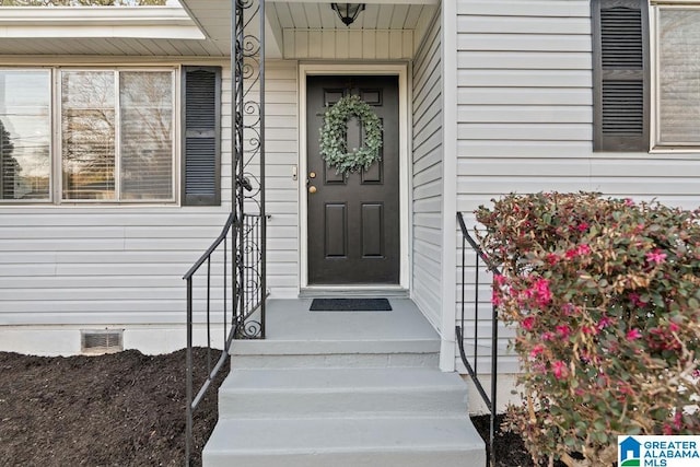 property entrance with crawl space and visible vents