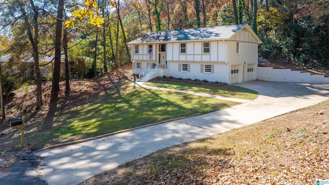 view of front of home with an attached garage, a shingled roof, board and batten siding, a front lawn, and driveway