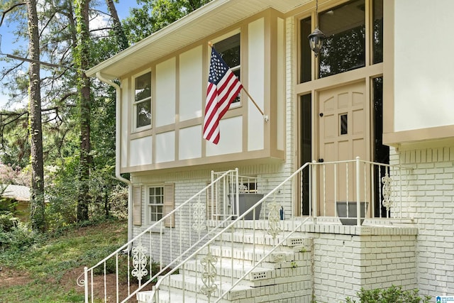 view of exterior entry with brick siding