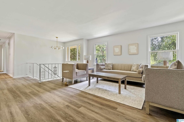 living room featuring an inviting chandelier and wood finished floors