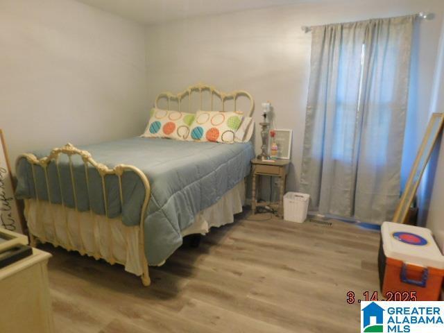 bedroom featuring wood finished floors