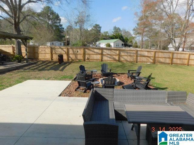 view of patio / terrace with a fire pit and fence