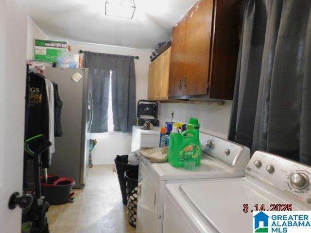 laundry room with washer and dryer and cabinet space